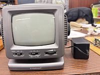 Front view of Supersonic FC-9200 TV with attached AC adapter