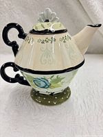 Profile of assembled teapot and cup showing pattern