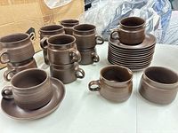 Group shot of all pieces: stacks of cups, saucer stack, creamer, sugar bowl