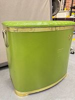 Full view of green ribbed vinyl hamper with lid and trim