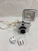 Front view of white Diana Mini camera with flash attached and two adapters