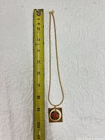 Full necklace beside tape measure showing length