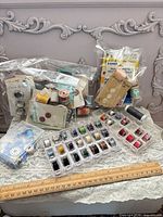 overview of lot with spools, bobbins, buttons and needles