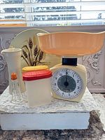 Group shot of all items including scale, containers, shaker, mill, tin