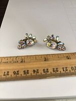 Front view of both earrings with ruler showing 1-inch width