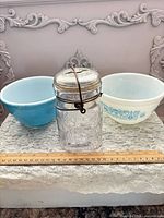 Overview of jar and two bowls with ruler for scale