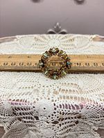 Front view of brooch with ruler showing size