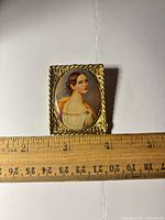 Front view showing portrait miniature and frame with ruler for scale