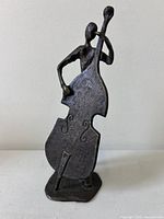 Front view of bronze abstract sculpture of musician with double bass