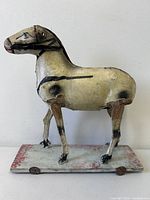 full side view of painted wooden horse on wheeled base