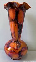 Full view showing entire Kralik iridescent orange and purple swirl trumpet vase