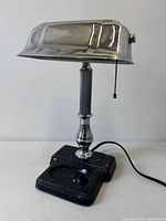 Front view of chrome banker lamp on marbled base