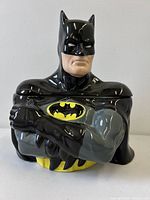 Front view of Batman cookie jar showing emblem and lid