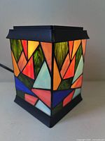 Front view of stained glass lamp showing multicolour geometric glass panels