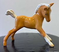 Left side view of glazed palomino foal figurine