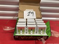 Open box showing ten cordless LED light switches
