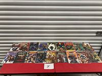 Row of 18 comic books on table