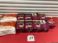 Overview of six Depend boxes and two Tranquility packs on table