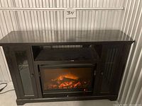 Front view of entire media console showing fireplace insert and side cabinets