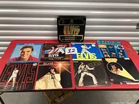 Overview of all Elvis Presley records and box set on table