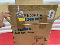 Opened Juki MO-600N Series cardboard box