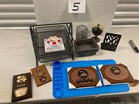 Lot overview showing letter tray, plaques, work mat, globe, organizers, baskets, bookends, playing cards