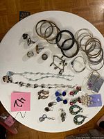 Overview of entire jewelry lot on round table