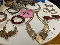 Assorted jewellery laid out showing necklaces, earrings, bracelets and hair accessories