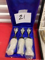 Three EPNS silver-plated bottle stoppers in blue satin-lined case