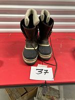 Front view of pair of winter boots upright on table