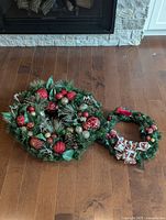 Front view of both wreaths showing decorations and relative sizes