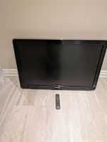 Front view of Philips 42" LCD TV with remote placed below