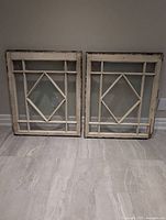 Front view of both antique windows showing overall design and condition