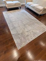 Full view of rug in room showing abstract pattern and color