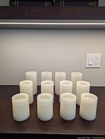 All 12 white flameless pillar candles displayed upright