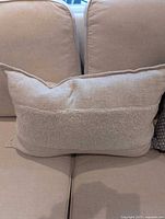 Beige lumbar pillow on couch
