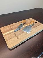 Board and two utensils arranged on top