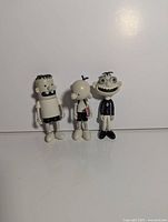 Front view of all three Funko figures standing side by side