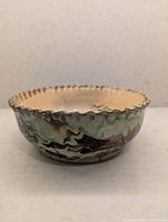 side view showing marbled exterior glaze and ruffled rim