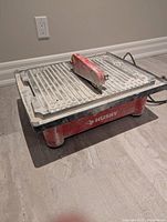 Front angle of red Husky wet tile saw