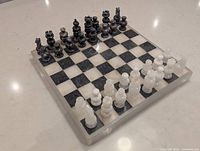 Oblique view of marble chess set showing board and pieces