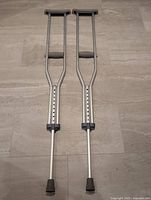 Full view of both aluminum crutches side by side