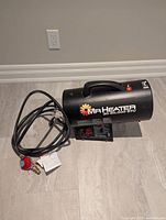 Left side view showing Mr. Heater branding, hose, regulator and control panel