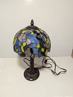 Front view of stained glass lamp showing full form and cord