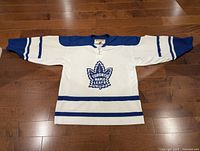 Front view of white and blue Maple Leafs KOHO jersey showing crest