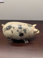 Left side view showing crackle glaze, stamp graphics, overall shape