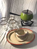 Group view of platter, sauce boat with underplate, four tumblers, green fondue pot on stand