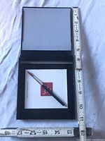 Open Buddha Board showing drawing surface, base tray, brush and tape for scale