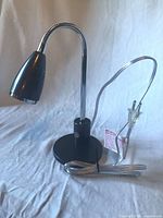 Angled view of assembled LED desk lamp showing base, neck, head, and cord