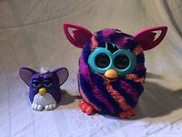 Front view of both Furby toys showing colors, sizes, and features